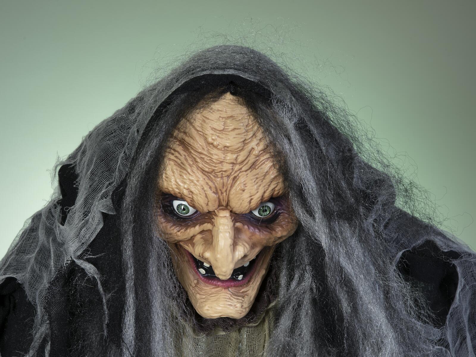 Animoitu musta ja harmaa Halloween-noitahahmo sauvan kanssa