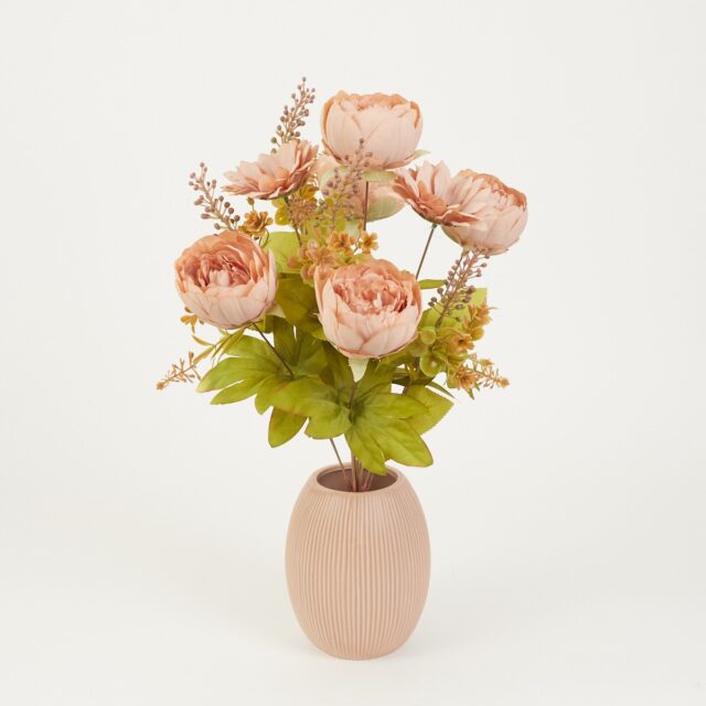 Persikanvärinen tekokukkakimppu pioneilla, auringonkukilla ja vihreillä lehdillä