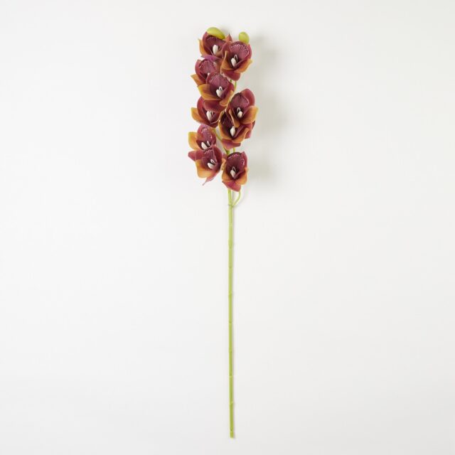 Silikoninen cymbidium-orkidean tekokukkaoksa viininpunaisen ja keltaisen sävyissä